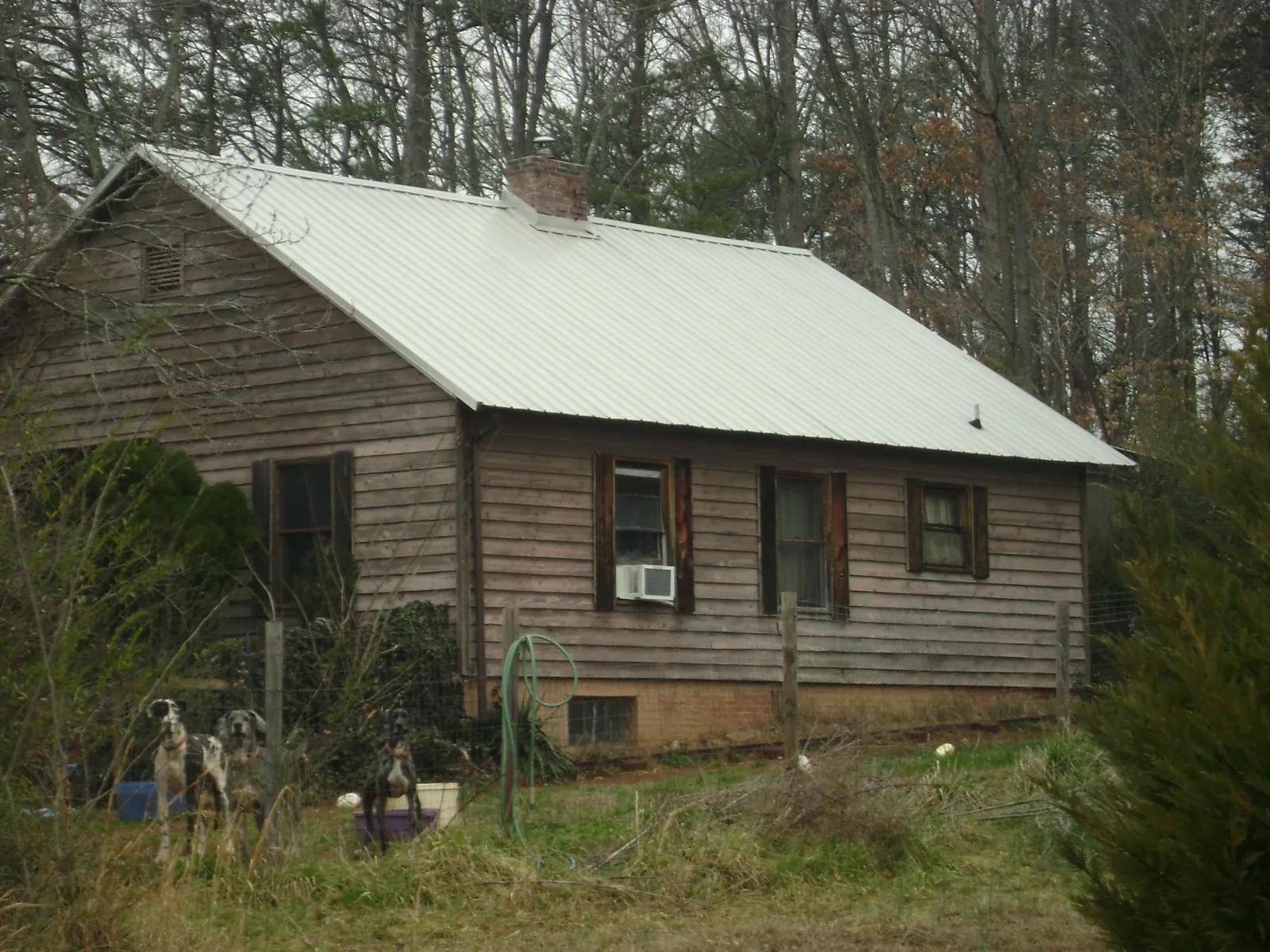 White metal roof on an old wood sided farmhouse, from a Metal Roof Installation job in Dunstable
